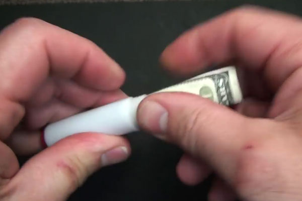 Human hands putting cash in a small container