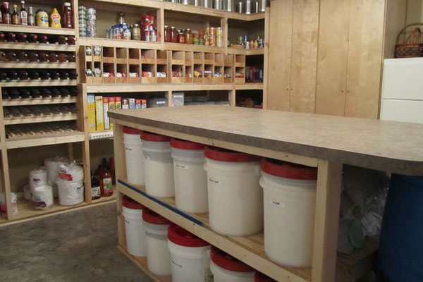 Storage room with shelves of food and plastic blows and plates