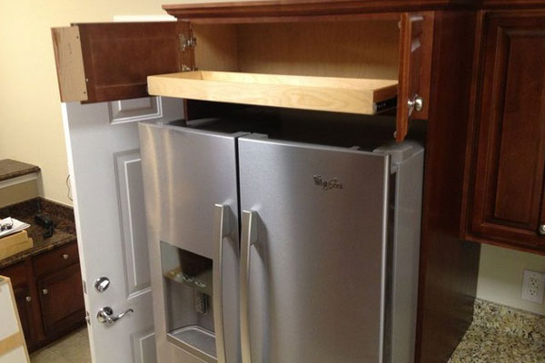 Opened shelves above a refrigerator