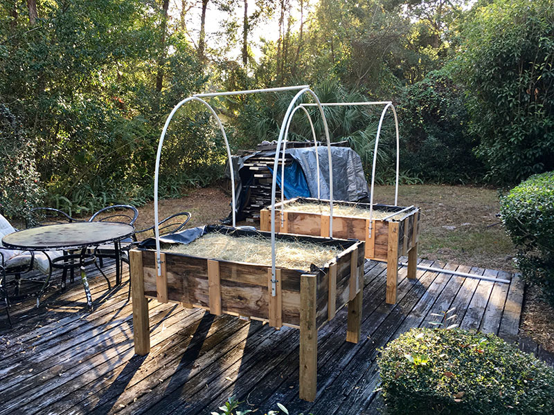 Wooden planter with PVC pipe on the back patio