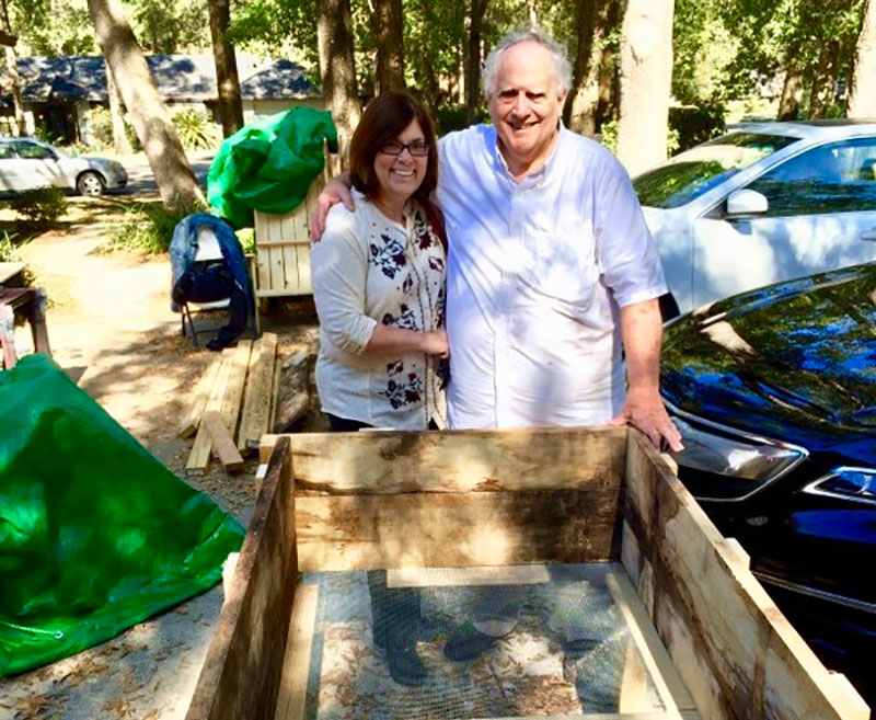 skip and jenny standing next to a raised bed planter ready for instruction