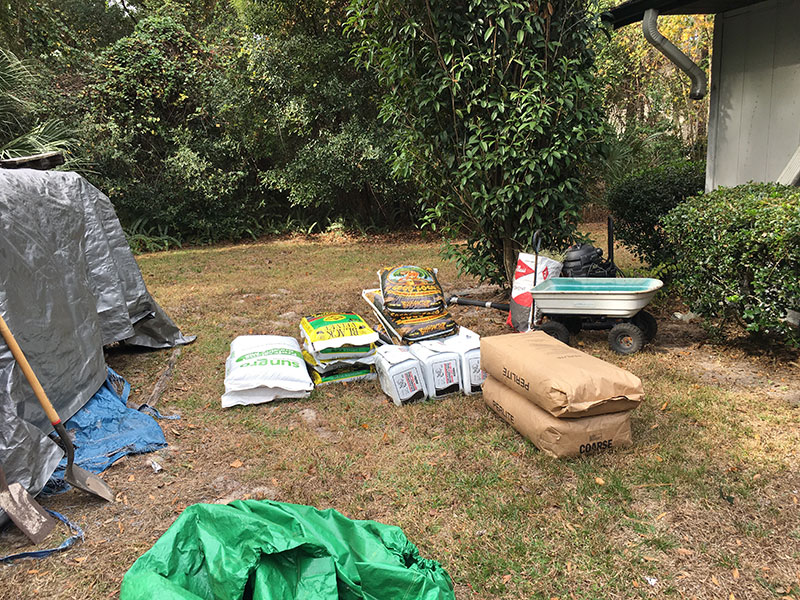 soil bags and other materials laid out and ready for use in the planters