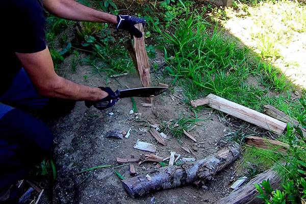 Man chopping wood with a knife