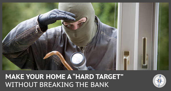 a burglar looking in a house window with a flashlight and crowbar