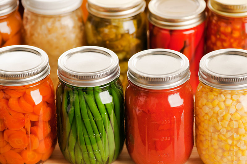 Carrots, beans, and corn preserved in glass jars