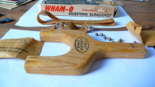Wooden frame slingshot with bands and metal ammo