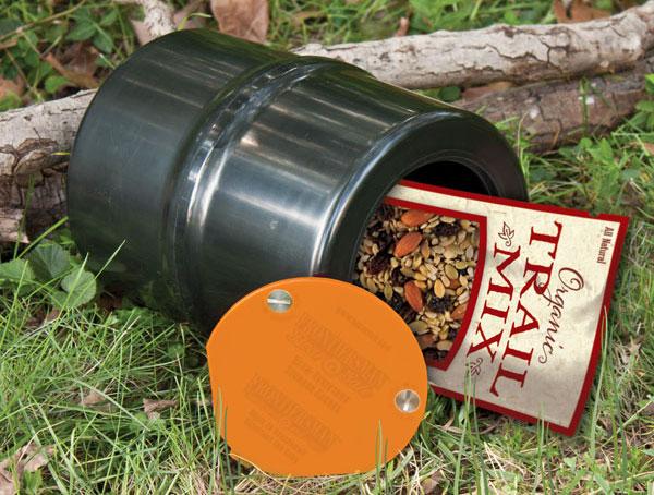 a metal storage can open on its side with trail mix in it