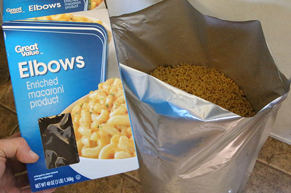 box of macaroni being dumped into sealable large storage bag