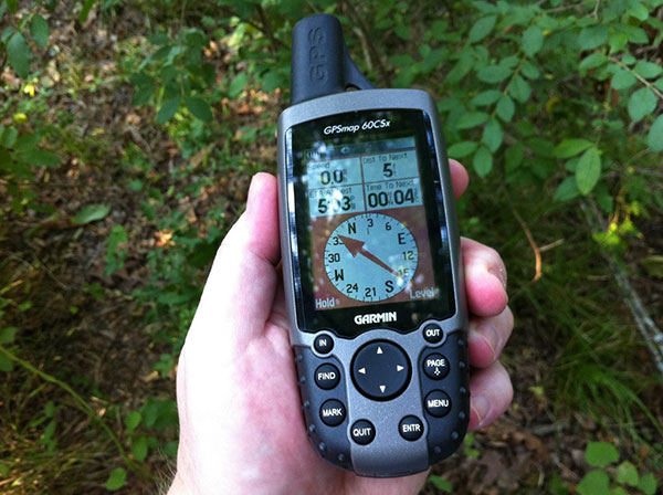 hand holding a digital gps device for navigation