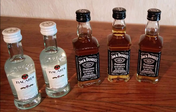 small bottles of bicardi liquor and jack daniels whiskey on a table