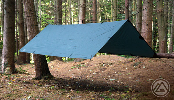 Paracord a-frame with a green tarp in the woods