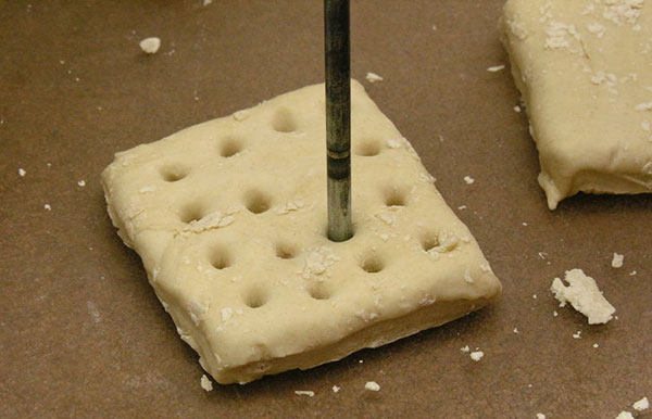 Small rod poking holes in hardtack dough