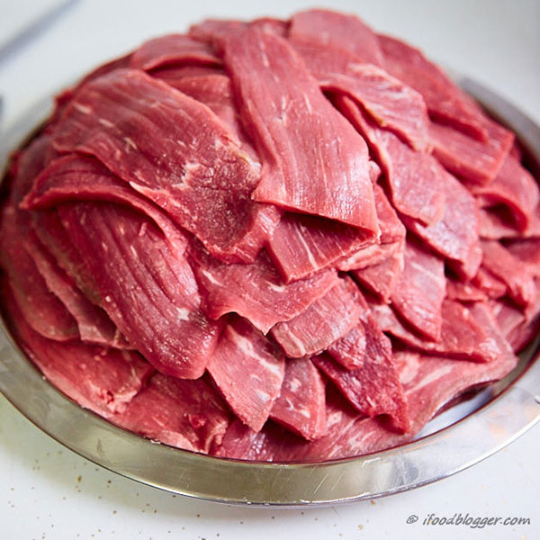 Raw meat in a metal bowl