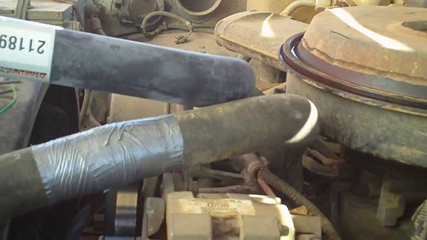 Inside a car's hood with duct tape covering hoses