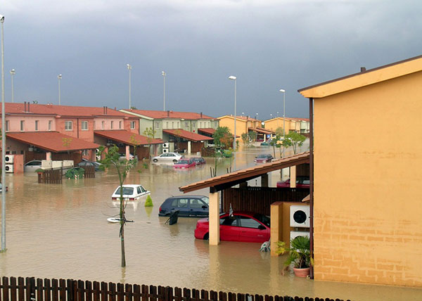 Houses and cars underwater in a flooding street