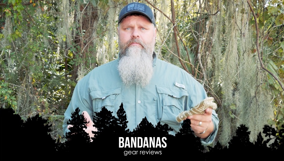 Man holding a bandana in the woods