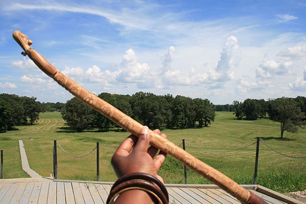 Hand holding an atlatl spear