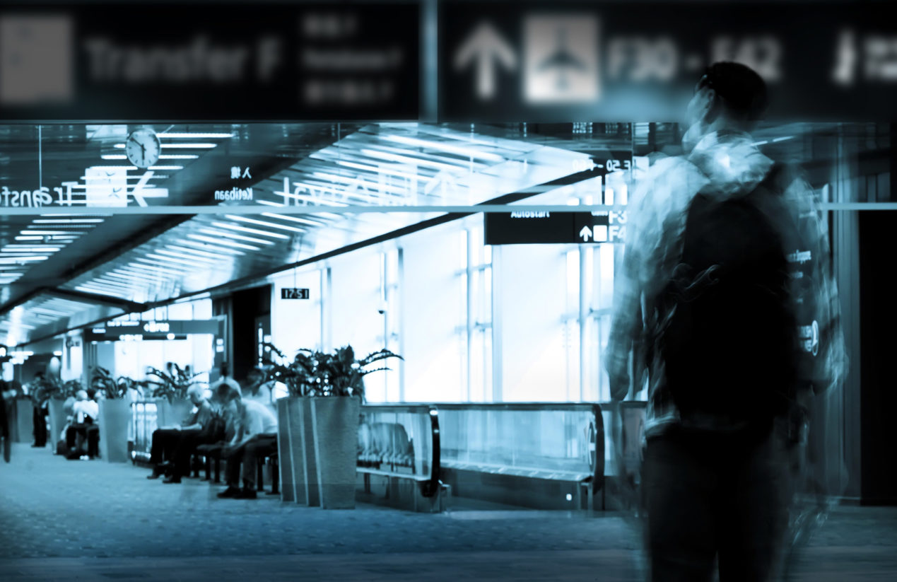 Person walking into the airport with a backpack