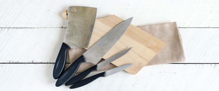 Knives laying on a wooden cutting board