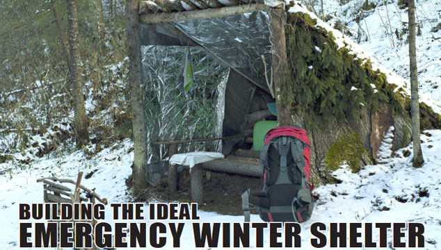 Emergency winter shelter built with mylar blankets, pine branches, and trees next to a backpack in the snow