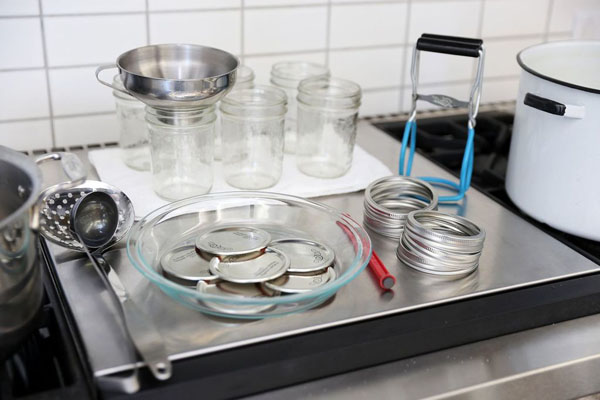canning equipment laid out on a counter for food preservation