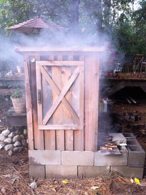Smoking shed for meat with smoke coming out of it