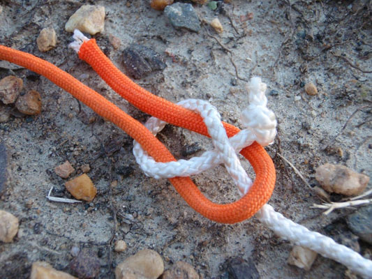 orange and white rope tied in a sheet bend knot