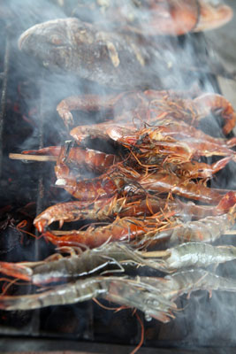 shrimp and fish on a smoker rack