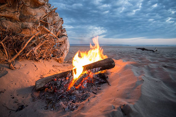 Building a fire on the beach